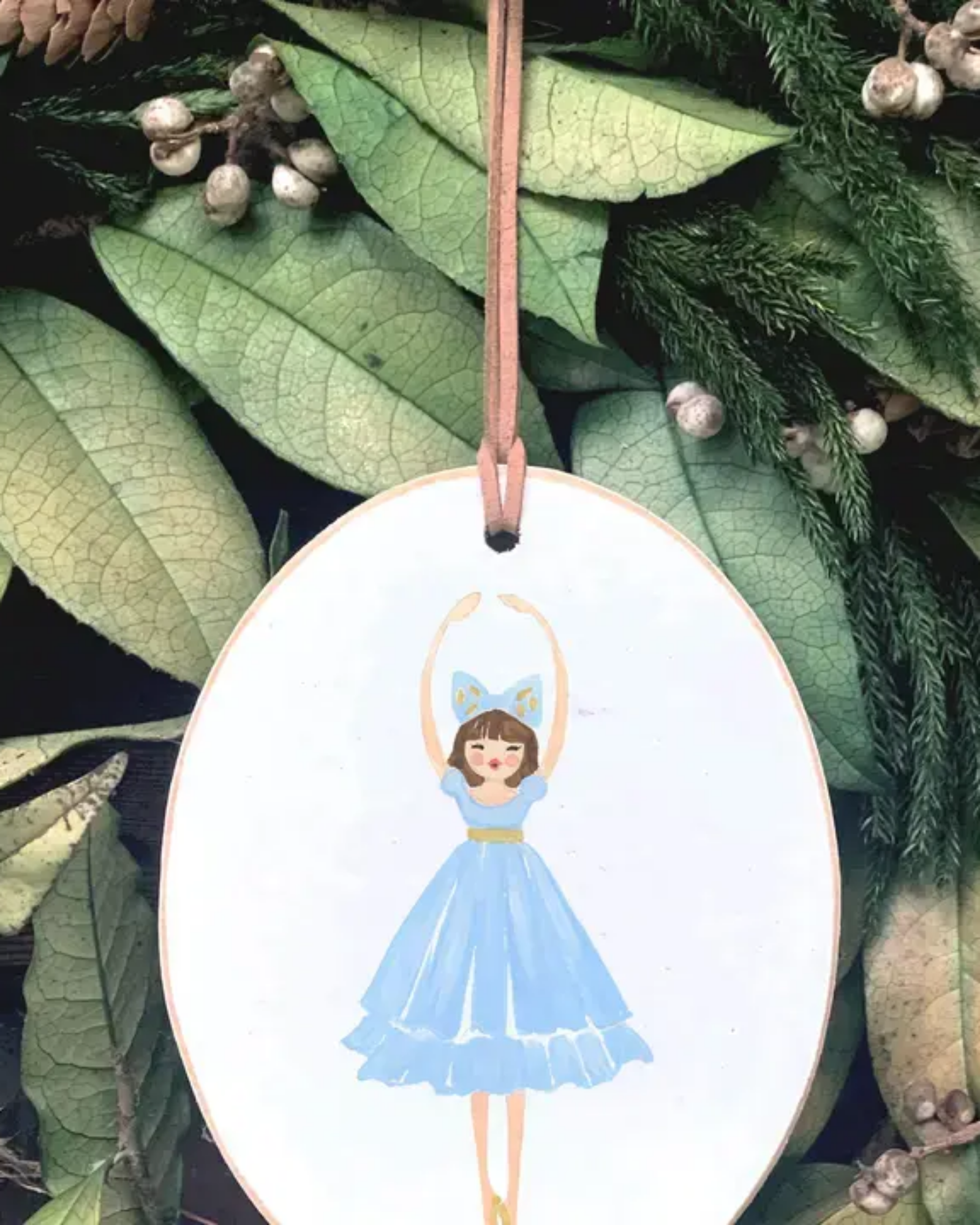 Decorative ornament with a fairy design on a leafy background