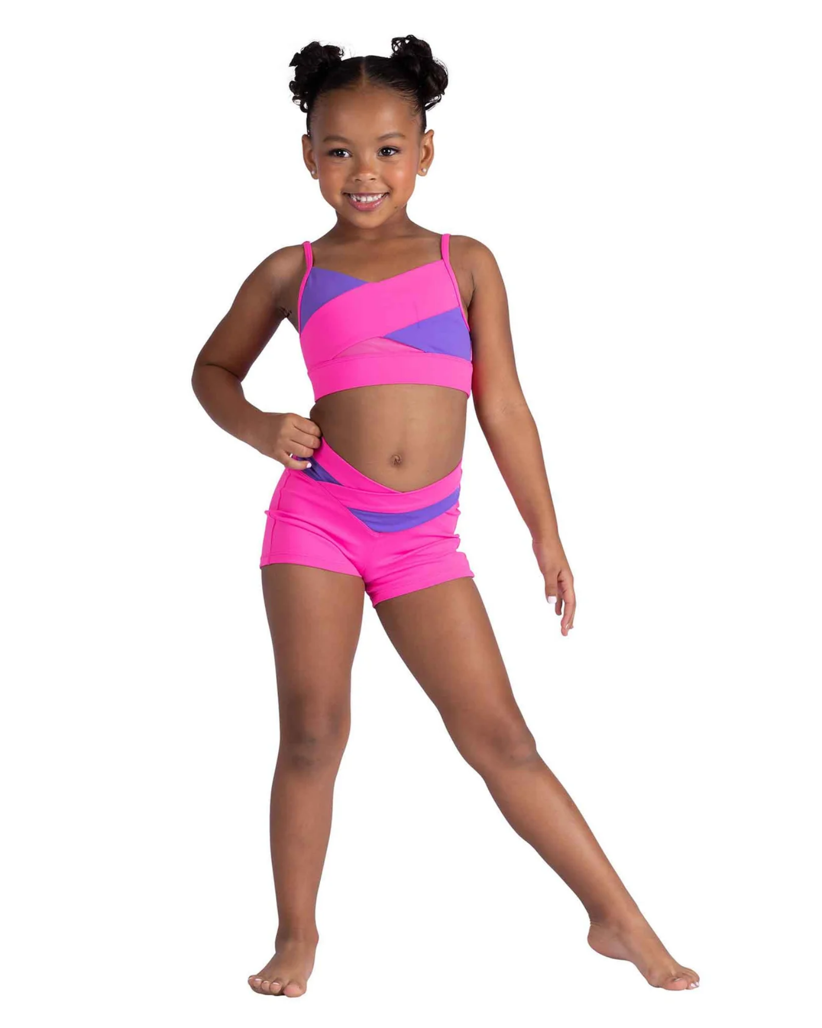 Young girl wearing a pink and purple dance outfit on a white background