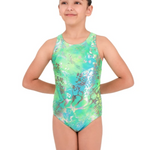 A young girl modeling a sleeveless one-piece gymnastics leotard with a green and blue abstract pattern, set against a plain white background.