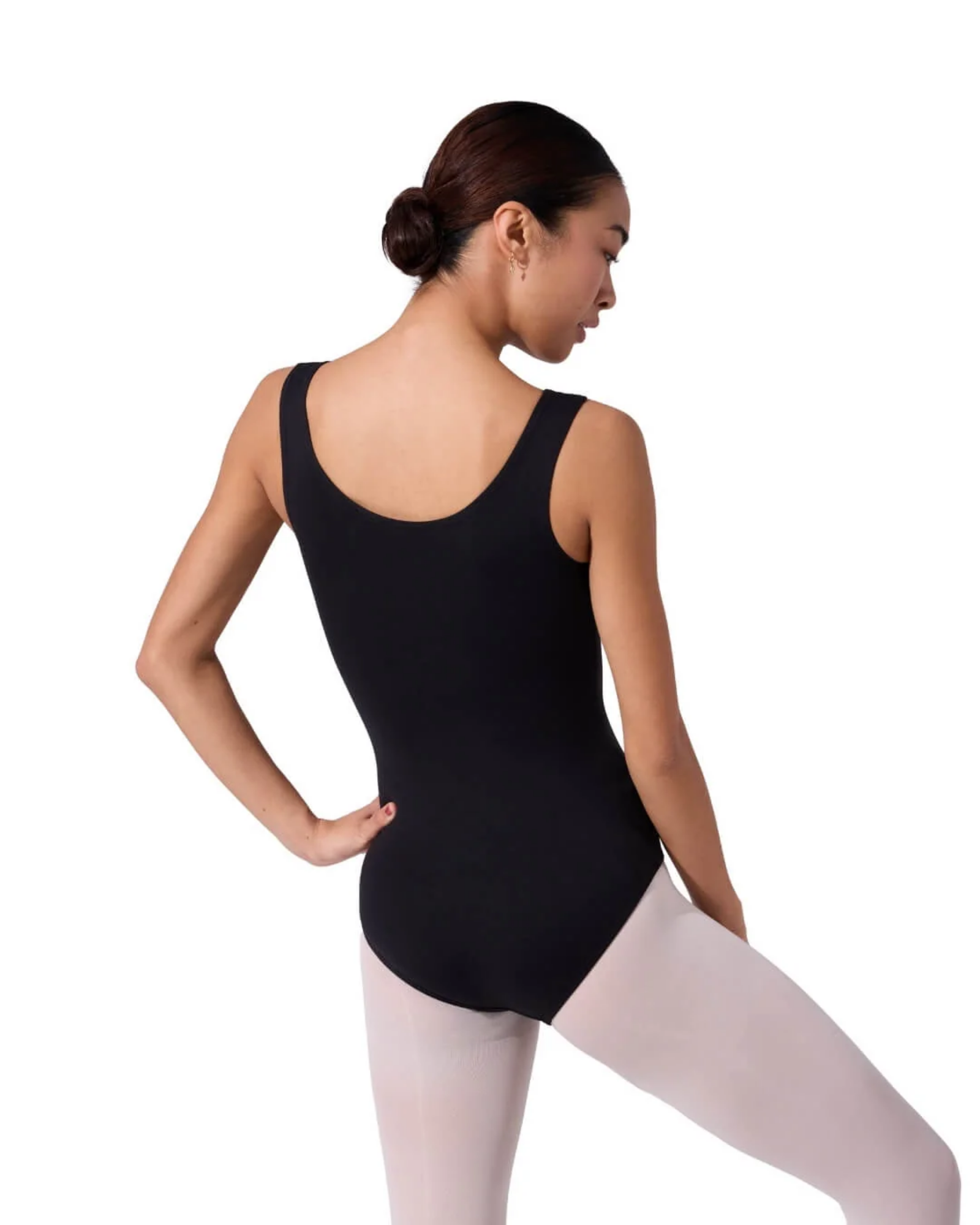Person wearing a black leotard and white tights on a white background