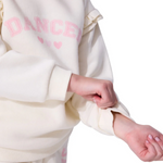 White sweatshirt with 'DANCE' printed in pink on a white background