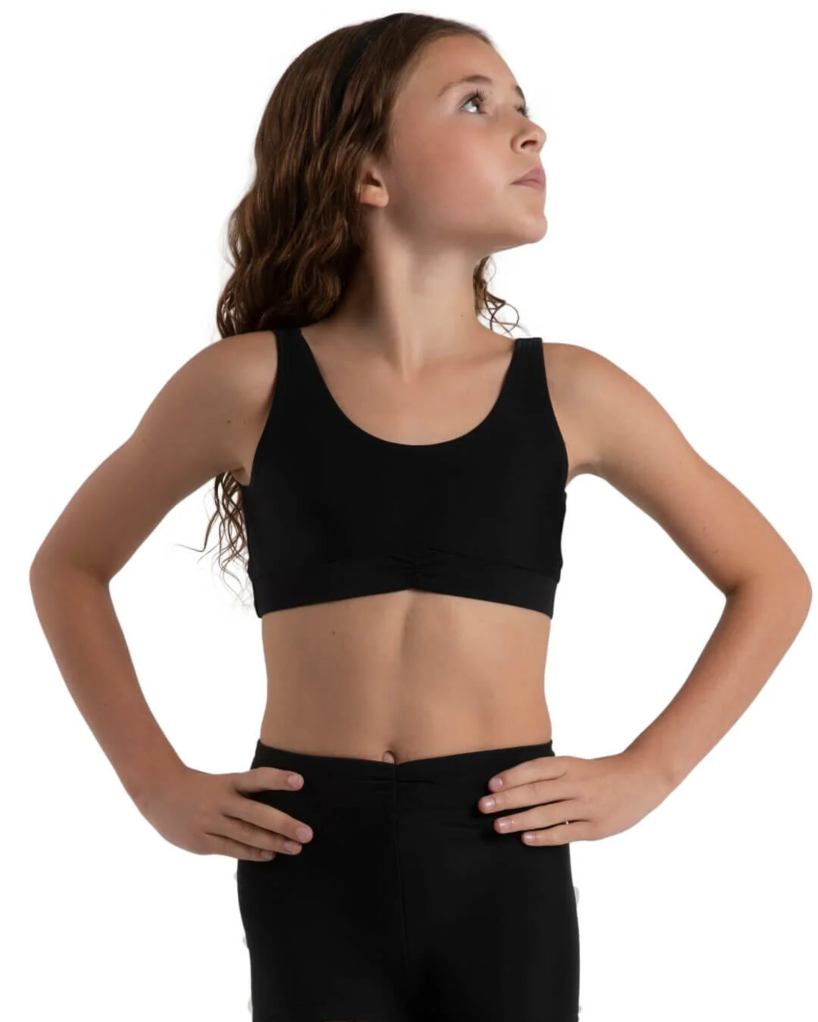 Woman wearing a black bra top and shorts on a white background