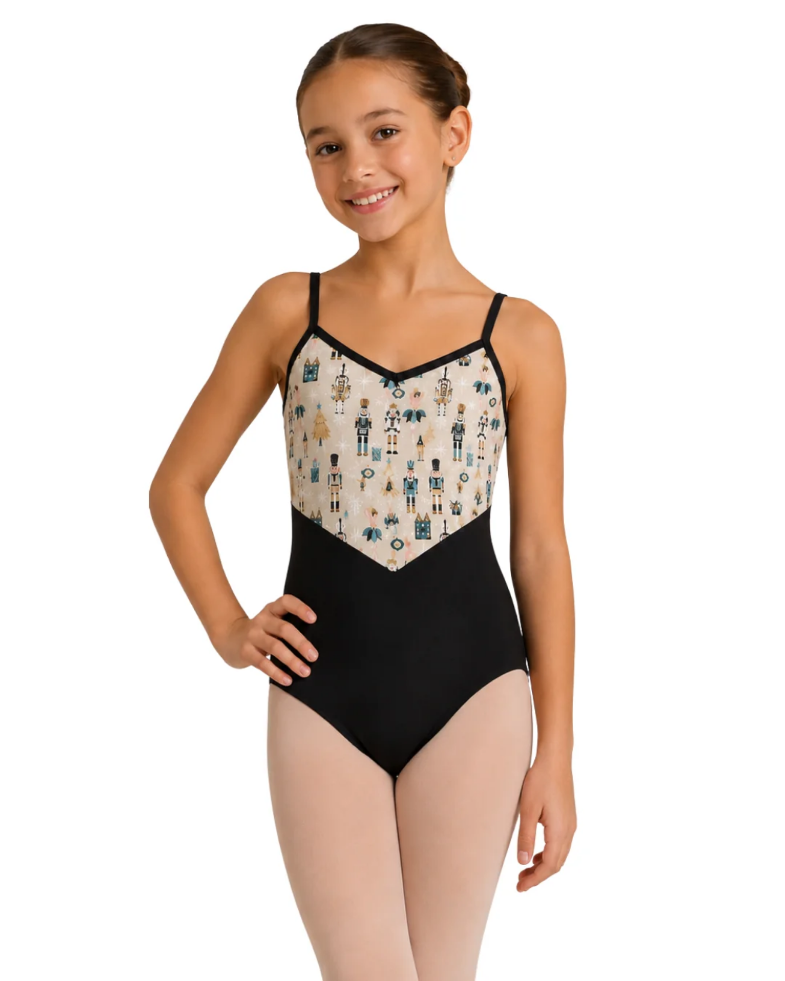 A young girl modeling a black leotard with a cream-colored patterned bodice featuring blue and gold ballet dancer illustrations, set against a plain white background.
