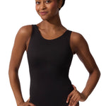 Woman wearing a black leotard on a white background