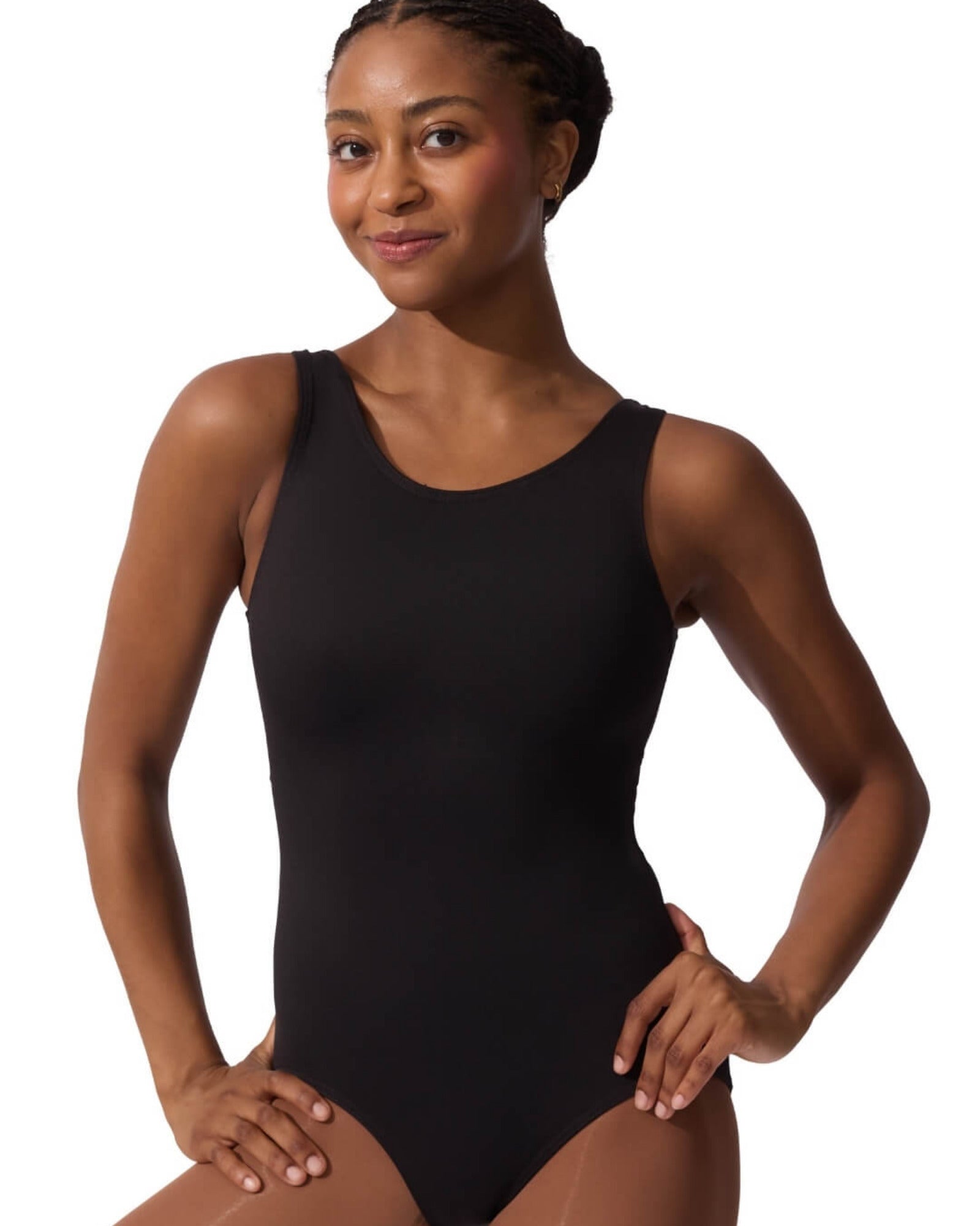 Woman wearing a black leotard on a white background