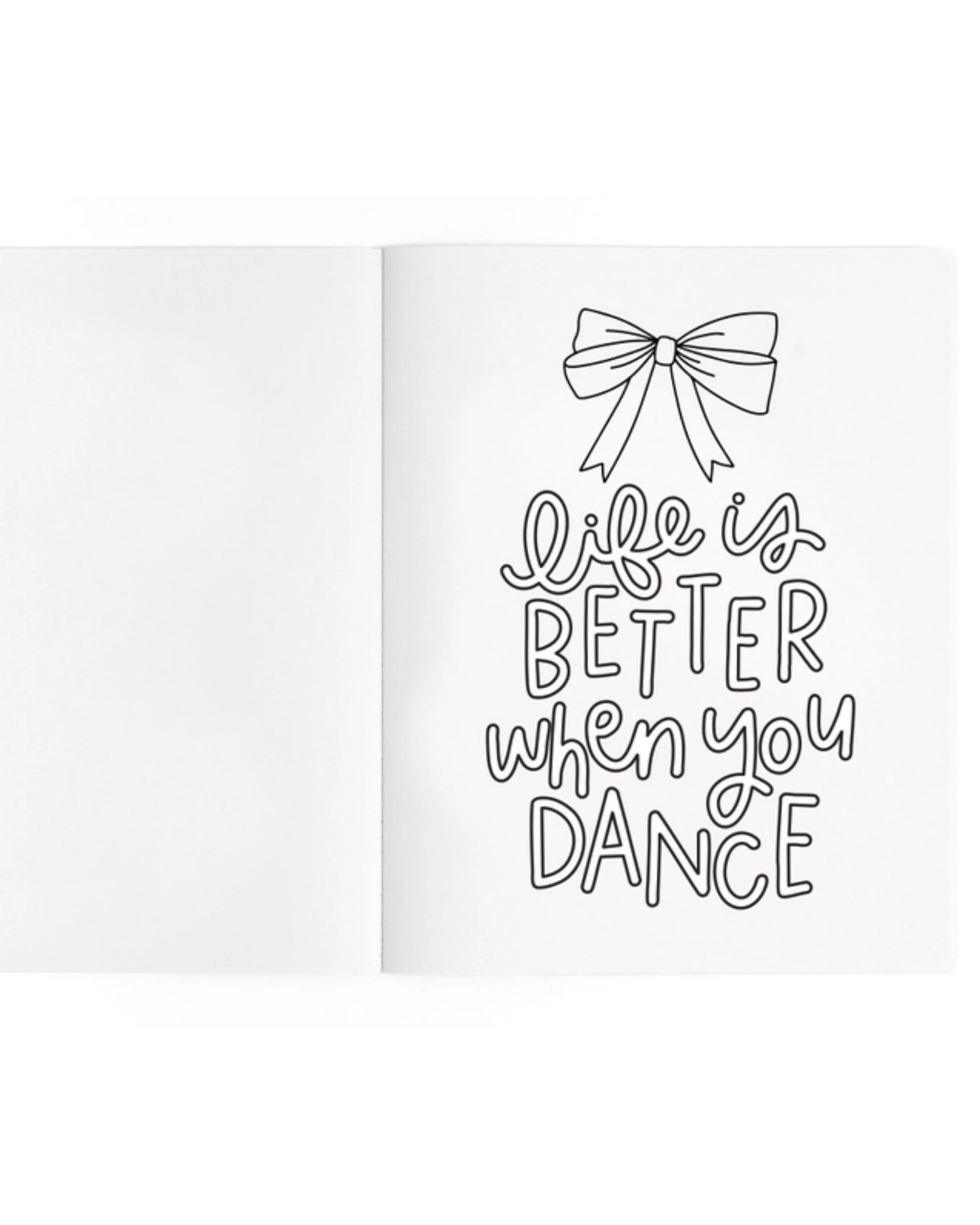 A white open notebook or journal spread on a white background, with black hand-lettered text on the right page reading 'Life is BETTER when you DANCE' beneath a simple bow illustration.