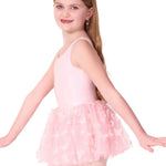 Young girl wearing a pink ballet outfit with a tutu on a white background