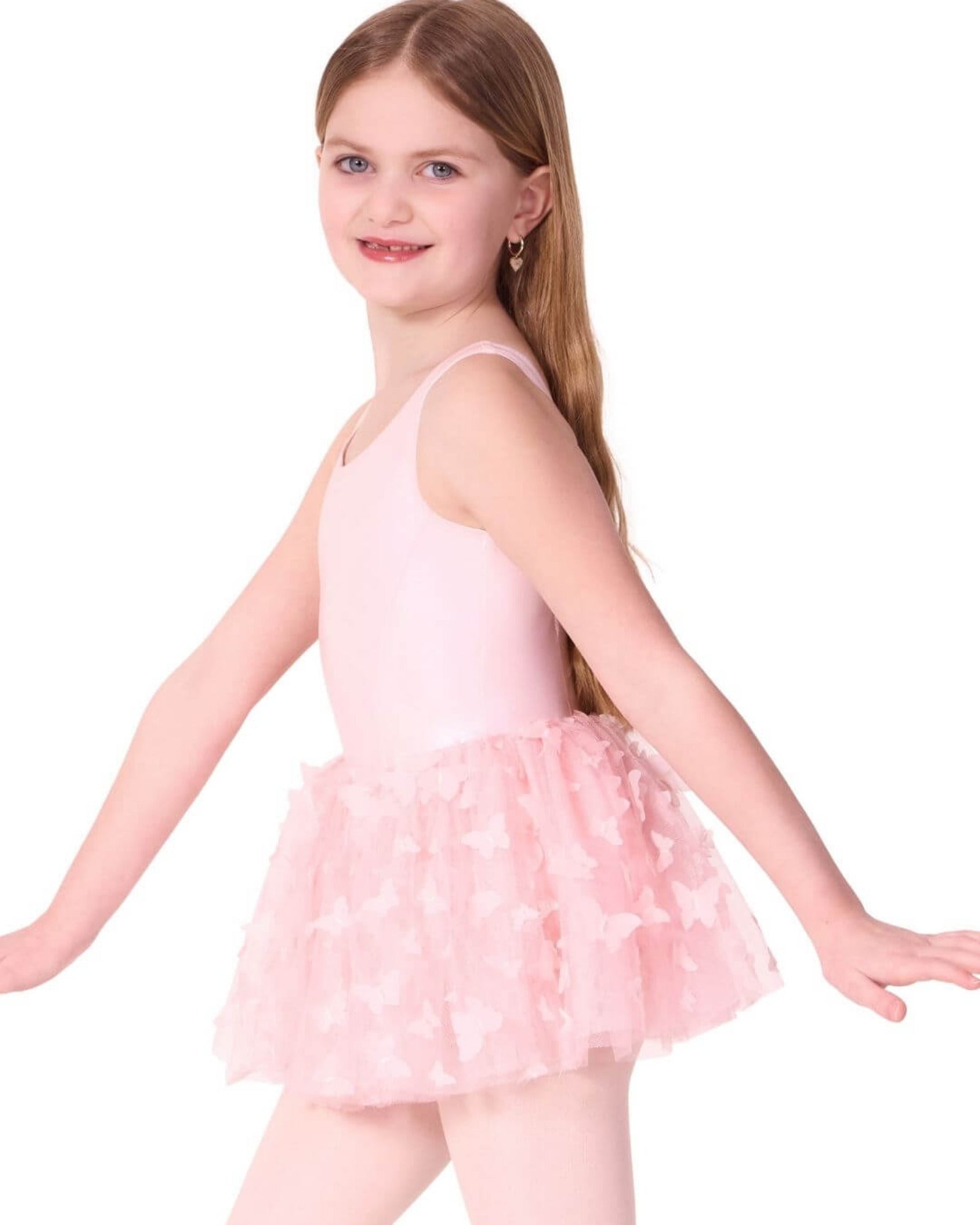 Young girl wearing a pink ballet outfit with a tutu on a white background